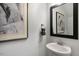 Small powder room with pedestal sink and framed art at 2334 Sugar Cone Way, Fuquay Varina, NC 27526