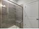 Shower with gray tile and built in seat at 2334 Sugar Cone Way, Fuquay Varina, NC 27526