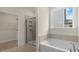 Bathroom with soaking tub, shower, and walk-in closet at 317 Umstead St, Sanford, NC 27330