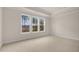 Spacious bedroom with neutral carpeting and multiple windows at 317 Umstead St, Sanford, NC 27330