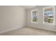 Well-lit bedroom with carpet flooring and large windows at 317 Umstead St, Sanford, NC 27330