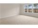 Bright bedroom with carpet and large windows overlooking wooded area at 317 Umstead St, Sanford, NC 27330