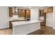 Island kitchen with stainless steel appliances and hardwood floors at 317 Umstead St, Sanford, NC 27330