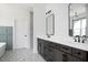 Elegant bathroom with a double vanity, large mirrors, and stylish fixtures at 321 Bud Wall Rd, Youngsville, NC 27596