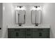 Elegant bathroom featuring dual sinks with black faucets, a marble countertop, and green cabinets at 321 Bud Wall Rd, Youngsville, NC 27596