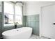 This modern bathroom has a freestanding tub with white walls and light green wood trim at 321 Bud Wall Rd, Youngsville, NC 27596