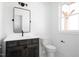 Charming bathroom with wood vanity, modern fixtures, and a decorative mirror and toilet at 321 Bud Wall Rd, Youngsville, NC 27596
