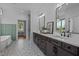 Bathroom features double vanities with marble countertops and a tile floor at 321 Bud Wall Rd, Youngsville, NC 27596