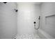 Bright shower features white subway tile and a shower head, accompanied by a decorative tile floor at 321 Bud Wall Rd, Youngsville, NC 27596