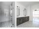 Modern bathroom with a walk-in shower, double vanity, and patterned tile flooring at 321 Bud Wall Rd, Youngsville, NC 27596