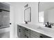 Modern bathroom with dual sinks, framed mirrors and a glass enclosed shower with marble styled tile at 321 Bud Wall Rd, Youngsville, NC 27596