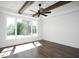 Bright bedroom with a large window, ceiling fan, and hardwood floors at 321 Bud Wall Rd, Youngsville, NC 27596