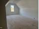 Unfinished bedroom featuring an attic window and clean, neutral walls ready for personalization at 321 Bud Wall Rd, Youngsville, NC 27596