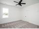 Bright bedroom with neutral carpet, a ceiling fan and a single window looks modern and fresh at 321 Bud Wall Rd, Youngsville, NC 27596