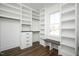 Organized walk-in closet with custom shelving and drawers, accompanied by a stylish wood bench at 321 Bud Wall Rd, Youngsville, NC 27596