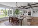 Elegant dining room featuring a large table, modern chandelier, and seamless flow to the living area at 321 Bud Wall Rd, Youngsville, NC 27596