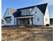 Front of a two-story home with a covered porch and a dark roof at 321 Bud Wall Rd, Youngsville, NC 27596