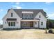 Charming two-story home with a brick porch and beautiful architectural details on a well-manicured lawn at 321 Bud Wall Rd, Youngsville, NC 27596