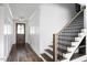 Elegant foyer with a wood door, leading to a staircase with wood and iron details at 321 Bud Wall Rd, Youngsville, NC 27596