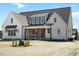 Beautiful two-story home with a charming front porch, brick accents, and lush landscaping at 321 Bud Wall Rd, Youngsville, NC 27596