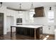Spacious kitchen with a large island, modern appliances, and stylish lighting fixtures at 321 Bud Wall Rd, Youngsville, NC 27596