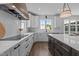 Bright kitchen features white cabinets, an island with a dark wood base, and modern stainless steel appliances at 321 Bud Wall Rd, Youngsville, NC 27596