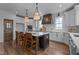 Contemporary kitchen features a central island, pendant lighting, and stylish wooden barstools at 321 Bud Wall Rd, Youngsville, NC 27596