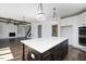 Open concept kitchen with a large island and adjacent living area at 321 Bud Wall Rd, Youngsville, NC 27596