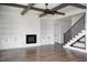 Beautiful living room features built-in shelves, fireplace, hardwood floors, and stair access at 321 Bud Wall Rd, Youngsville, NC 27596