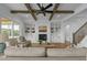 Spacious living room with a fireplace, built-ins, wood beams, and comfortable seating at 321 Bud Wall Rd, Youngsville, NC 27596