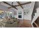 Bright living room with fireplace, built-in shelving, wood beams, and a cozy seating arrangement at 321 Bud Wall Rd, Youngsville, NC 27596