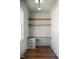 Home office features a built-in desk with drawers and open wood shelving for storage at 321 Bud Wall Rd, Youngsville, NC 27596