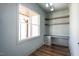 This home office features a built-in desk, wood shelves, and a window for natural light at 321 Bud Wall Rd, Youngsville, NC 27596