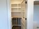 Walk-in pantry boasts custom shelving and countertops for organized storage solutions at 321 Bud Wall Rd, Youngsville, NC 27596