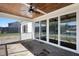 Covered porch with stone flooring, a wood ceiling, sliding doors, and ceiling fans for outdoor comfort at 321 Bud Wall Rd, Youngsville, NC 27596