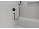 Tiled shower with built-in bench and matte black shower fixtures at 321 Bud Wall Rd, Youngsville, NC 27596