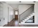 Stylish staircase with wood treads, black iron railings, and built-in shelving underneath at 321 Bud Wall Rd, Youngsville, NC 27596