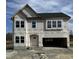 New two-story home boasts black roof, white windows, and a spacious two-car garage at 364 Pecan Valley Way, Four Oaks, NC 27524