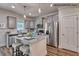 Modern kitchen with stainless steel appliances, gray cabinets, granite countertops, and a center island at 364 Pecan Valley Way, Four Oaks, NC 27524