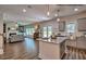 Open-concept living area seamlessly connects to the kitchen, featuring hardwood floors and a large center island at 364 Pecan Valley Way, Four Oaks, NC 27524