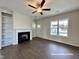 Living room with fireplace, built-in shelves, and hardwood floors at 389 Springtooth Dr, Zebulon, NC 27597