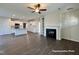 Open concept living room and kitchen with hardwood floors and a fireplace at 389 Springtooth Dr, Zebulon, NC 27597