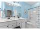 Clean bathroom with light blue walls, double vanity, and tub at 413 Holding Creek Dr, Wake Forest, NC 27587