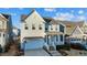 Charming two-story home with a covered front porch, attached garage, and manicured landscaping at 413 Holding Creek Dr, Wake Forest, NC 27587
