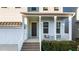 Charming front porch with white railings, a dark brown door, and brick steps at 413 Holding Creek Dr, Wake Forest, NC 27587