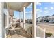 Relaxing front porch with white railings, two wicker chairs and a view of the street at 413 Holding Creek Dr, Wake Forest, NC 27587