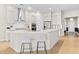 Modern kitchen with white cabinets, stainless steel appliances, and a large island at 413 Holding Creek Dr, Wake Forest, NC 27587