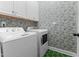 Convenient laundry room with washer, dryer, and green tile floor at 413 Holding Creek Dr, Wake Forest, NC 27587