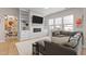 Living room features sectional sofa and built-in shelving at 413 Holding Creek Dr, Wake Forest, NC 27587