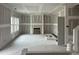 Unfinished living room featuring natural light, an inset fireplace, and neutral walls at 46 Shortstop Cir, Four Oaks, NC 27524